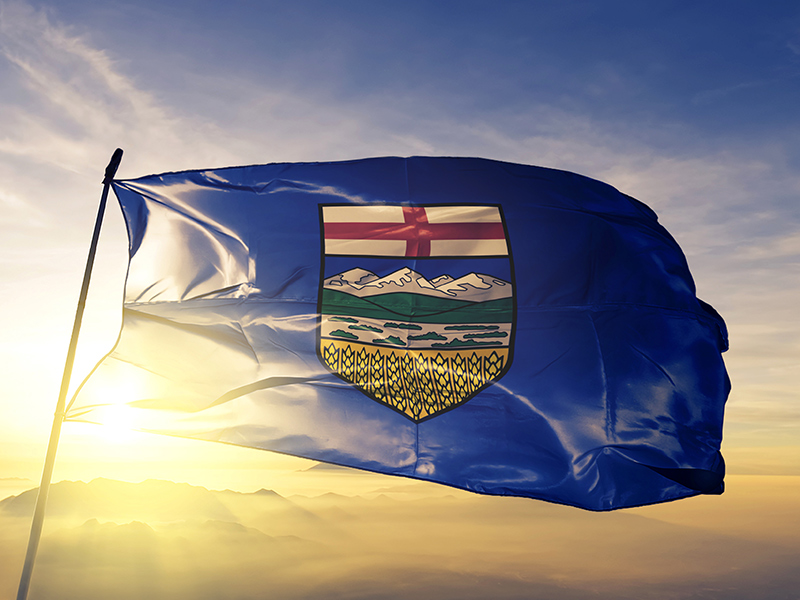 Alberta flag in front of setting sun
