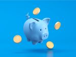 Piggy bank and coins on blue background