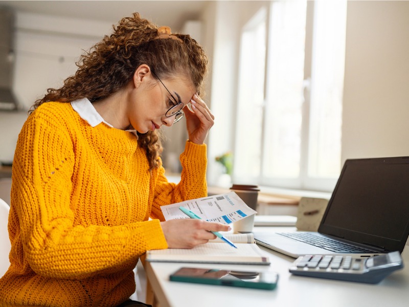 Worried young woman organizing her finances