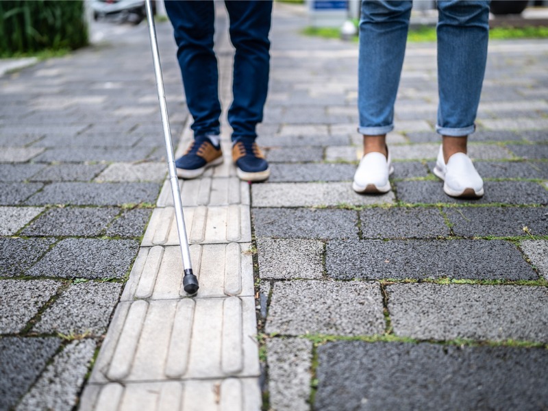 Visually impaired person walking in the street