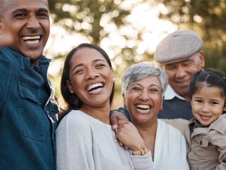 Three-generation family takes a photo in a park