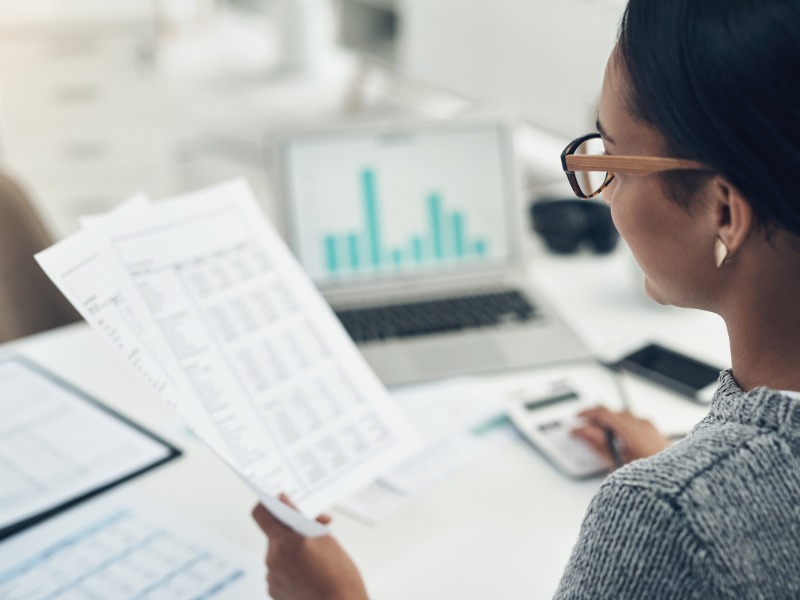 Businesswoman calculates finances in an office