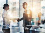 People shaking hands in a boardroom