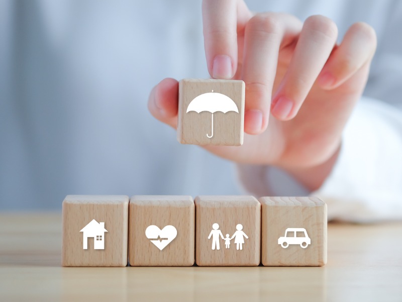 Insurance concept illustrated using wooden blocks