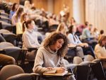 Woman writing an exam in a classroom