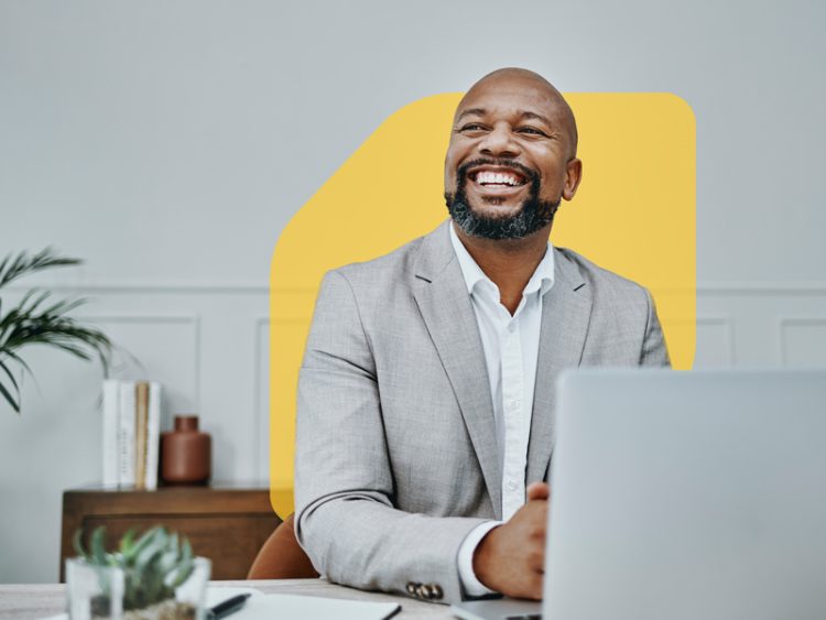 Mature professional businessman with grey hair looking at camera and smiling.