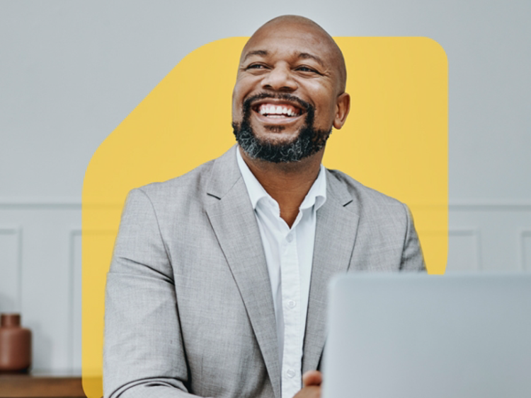 Mature professional businessman with grey hair looking at camera and smiling.