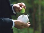 man putting a leaf in the piggybank